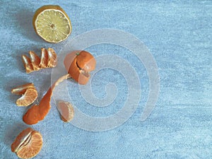 Peeled mandarin without peel and slices of ripe mandarin are on the table