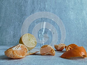 Peeled mandarin without peel and slices of ripe mandarin are on the table