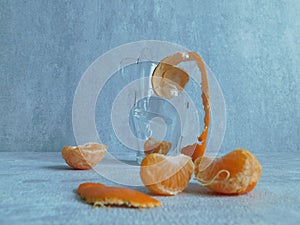 Peeled mandarin without peel and slices of ripe mandarin are on the table