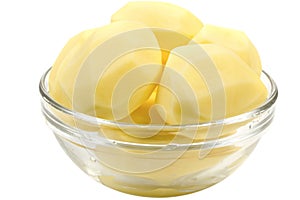 Peeled potatoes in a glass bowl