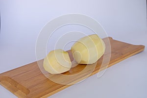 Potatoes are on a wooden board. photo