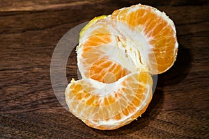 Peeled tangerine closeup with brown wooden table background stock image