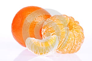 Peeled tangerine or mandarin fruit on white