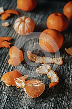 peeled tangerines on a rustic gray table