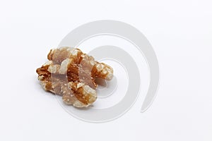 A peeled walnut on a white background