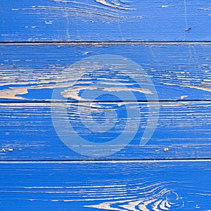 Peeling blue paint on hull of old ship