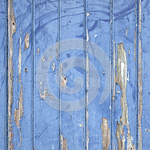 Peeling blue paint on wooden door or fence