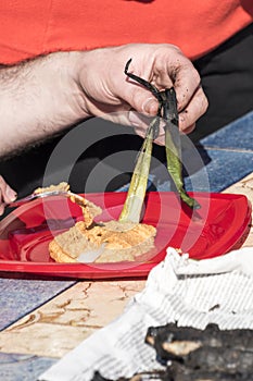 Peeling calÃ§ots or sweet onions in a calÃ§otada in Valls, Tarragona, Catalonia, spain.