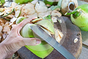 Peeling coconuts with chopping knife