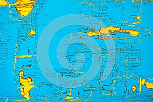 Peeling and cracked blue and yellow painted wood background