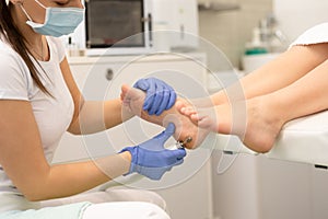 Peeling feet pedicure procedure in a beauty salon