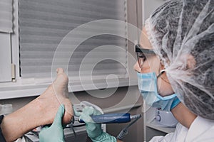 Peeling feet pedicure procedure in a beauty salon
