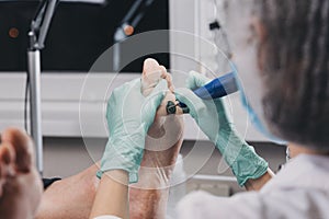 Peeling feet pedicure procedure in a beauty salon