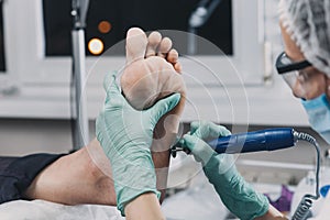 Peeling feet pedicure procedure in a beauty salon