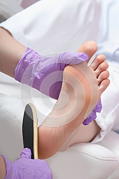Peeling feet pedicure procedure in SPA salon
