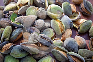 Peeling fresh almonds on an outdoor table in a sunny summer day. Home grown bio  food, farm life, country life