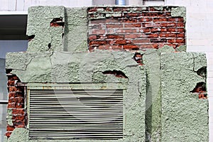 Peeling green plaster on a brick transformer box. background for the image of devastation and mismanagement. Russia photo