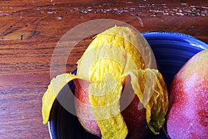 Peeling a mango in central America