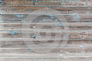 Peeling paint on old wooden rustic material on the wall.