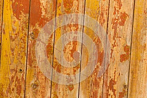 Peeling paint on old wooden rustic material on the wall.