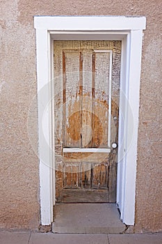 Peeling paint patterns on wooden entry door