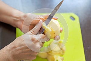 Peeling potatoes close up.