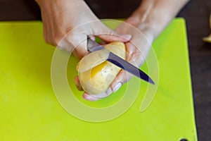 Peeling potatoes close up.