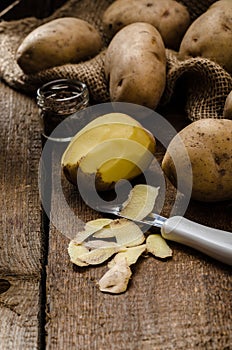 Peeling potatoes for gnocchi dougn on