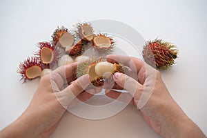 Peeling rambutan fruits from shell