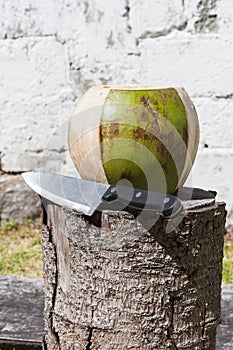 Peeling a ripe coconut with a knife