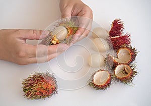 Peeling of tropical rambutan fruit