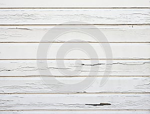 Peeling white paint on horizontal wooden planks