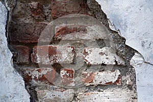 Peeling White Wall Revealing Red Bricks