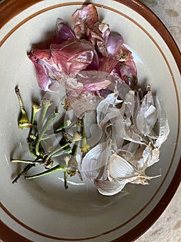Peels from shallots, garlic and chili stalks which can be used to eradicate insects.