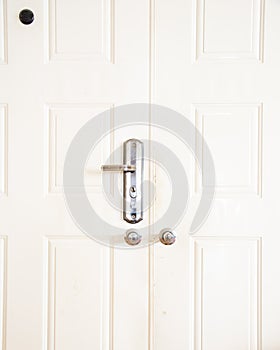 Peephole or peek hole of metal entrance door, rustic keyed entry door handle at apartment in Hanoi, standard door handle knob lock