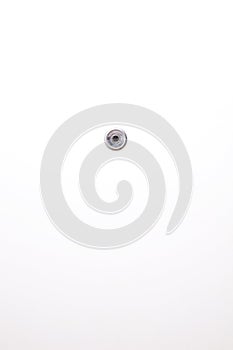 A peephole viewer on the center of the white door