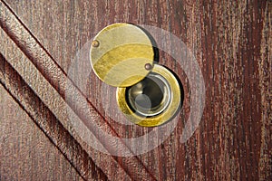 Peephole on wooden door - judas hole spyhole