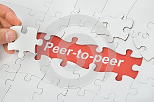Peer-to-peer text under white jig saw puzzle photo