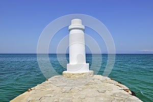 Pefkohori, Kassandra, Chalkidiki, Halkidiki, Greece. Lighthouse on the end of a pier in the Aegean Sea