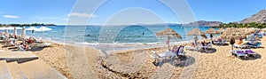 Pefkos beach with holiday-makers, sun beds and umbrellas in village of Pefkos - PANORAMA Rhodes, Greece