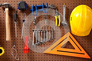Peg board with tools and hard hat photo