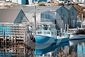 Peggy's Cove harbor - fishing boat and storage houses