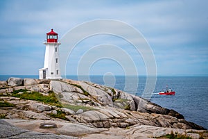 Peggy's Cove Lighthouse with red fisherman boat, Nova Scotia, Canada