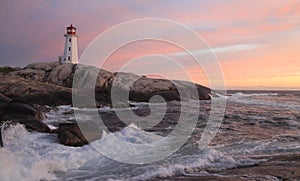 Peggyâ€™s Cove Lighthouse illuminated at sunset, Nova Scotia
