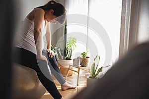 Pegnant woman at home resting after exercise