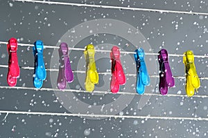 Pegs on a washing line in the rain