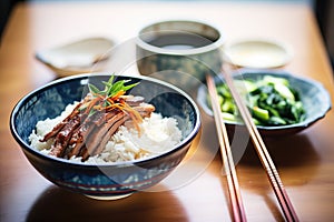 peking duck and rice in a bowl