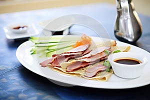 peking duck slices with pancakes and hoisin sauce