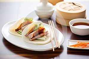 peking duck with steamed buns on side