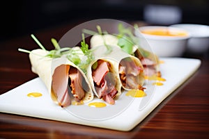 peking duck wraps with sauce in a row